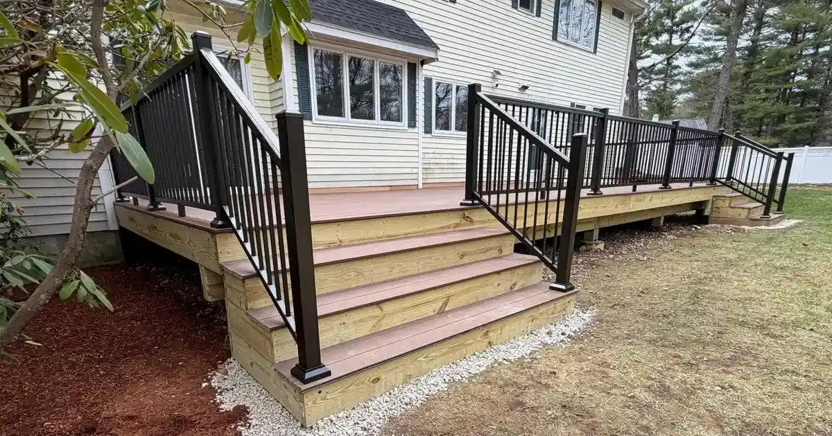 New composite deck with exposed wood framing accents and black aluminum railings