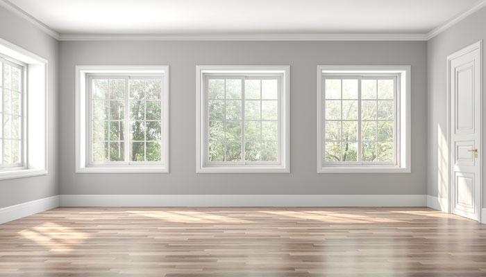 Newly painted house interior with neutral gray walls, natural light, and updated living space finishes