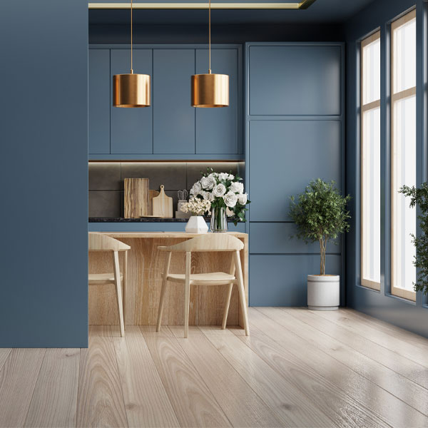 Modern kitchen and dining area featuring freshly painted blue walls, custom cabinetry, and updated interior finishes