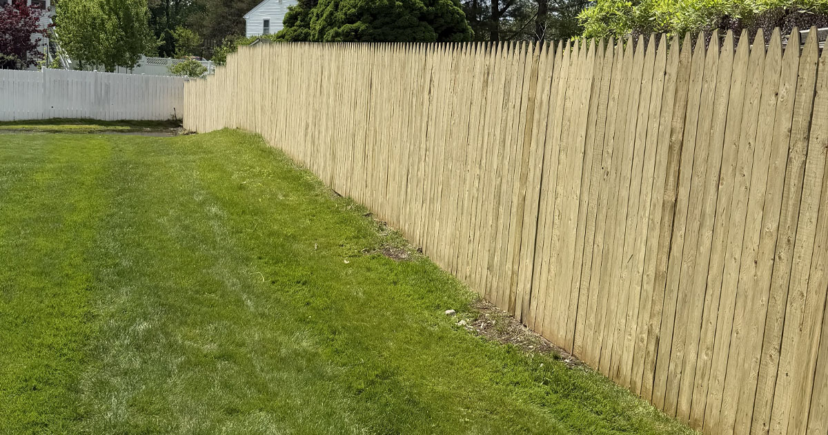 Custom wood privacy fence completed by White Pine Builds.