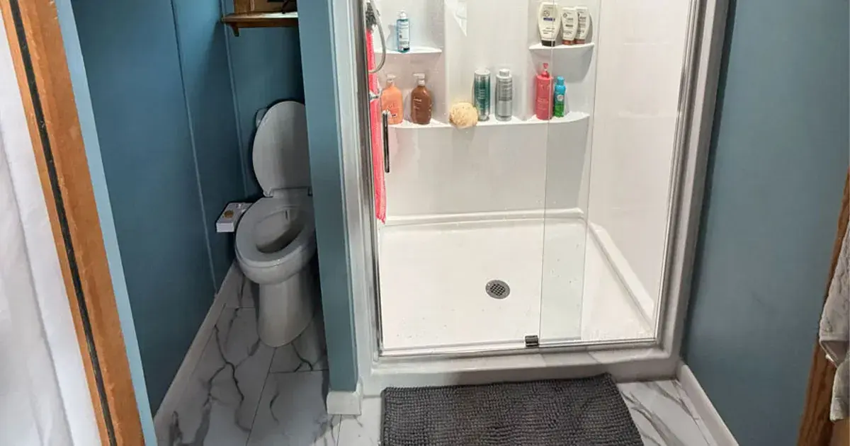 Remodeled bathroom with a custom walk-in shower, new tile flooring, and updated vanity