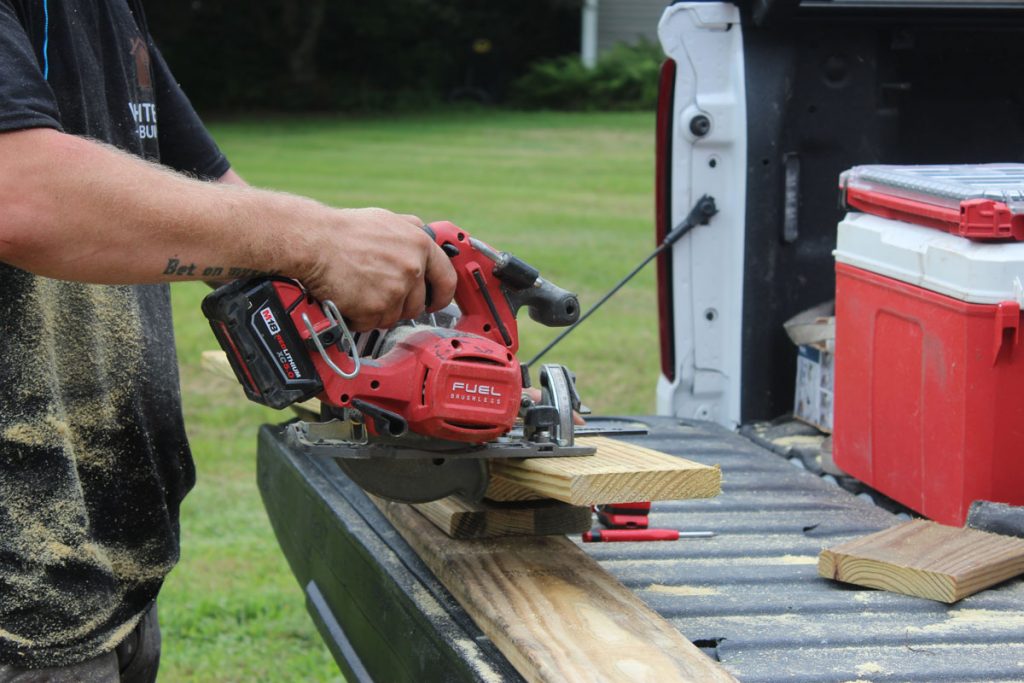 White Pine Builds contractor cutting lumber with a circular saw for a residential remodeling project.