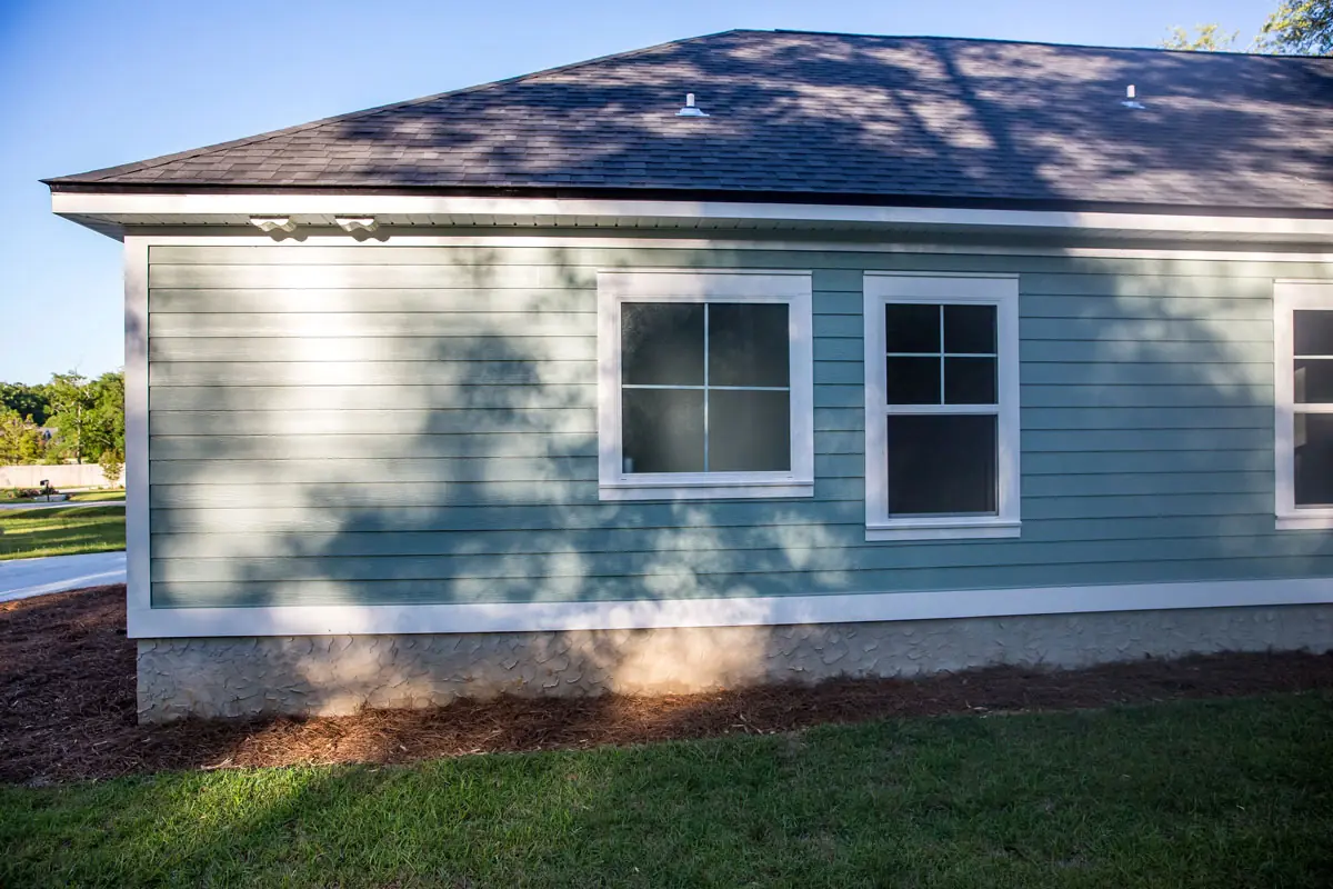 Exterior home maintenance and repair work on a residential house with finished siding and trim