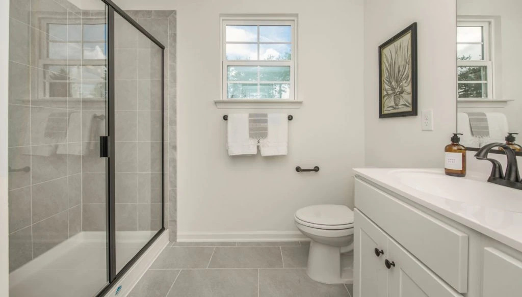 Luxury bathroom remodel featuring a custom tile walk-in shower, bathroom vanity installation, modern fixtures, and durable tile flooring.