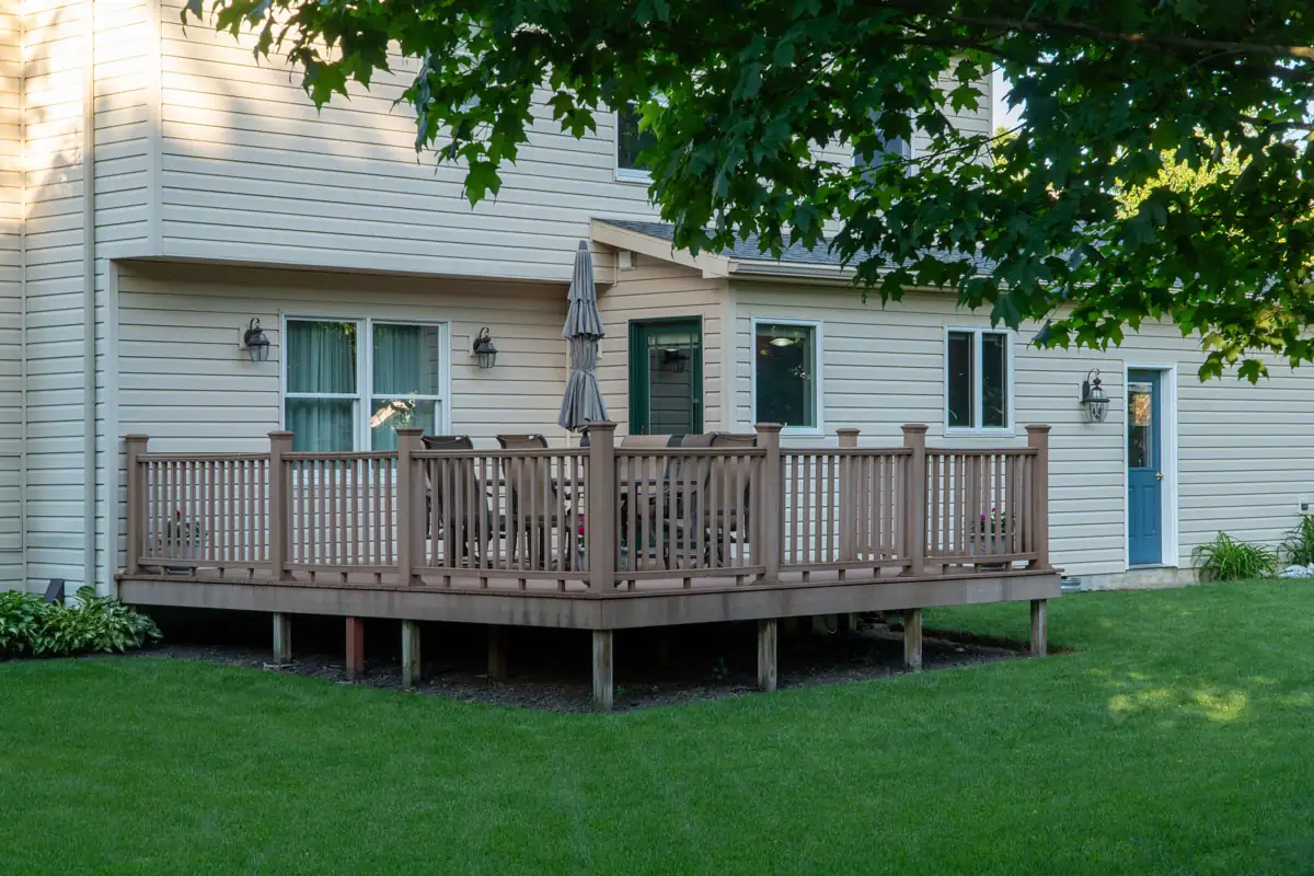 Residential deck with railing and outdoor seating attached to a home in Hampshire County, MA